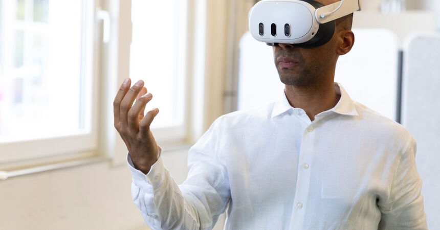 Person nutzt eine Virtual-Reality-Brille zur Interaktion mit einer digitalen Umgebung.